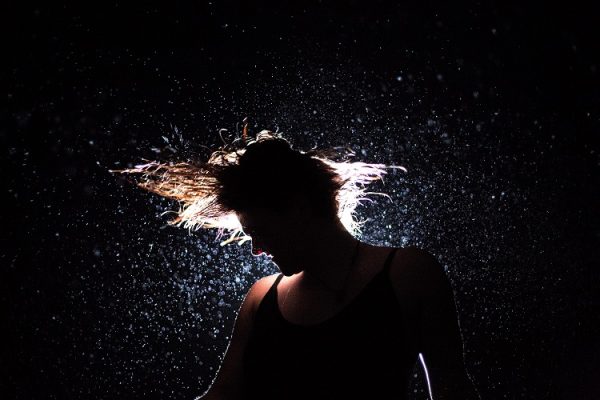 Woman shaking energetically stress and tension off her body and mind