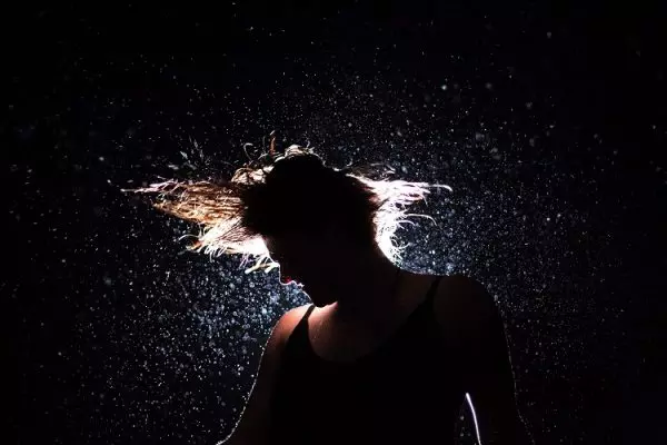 Woman shaking energetically stress and tension off her body and mind