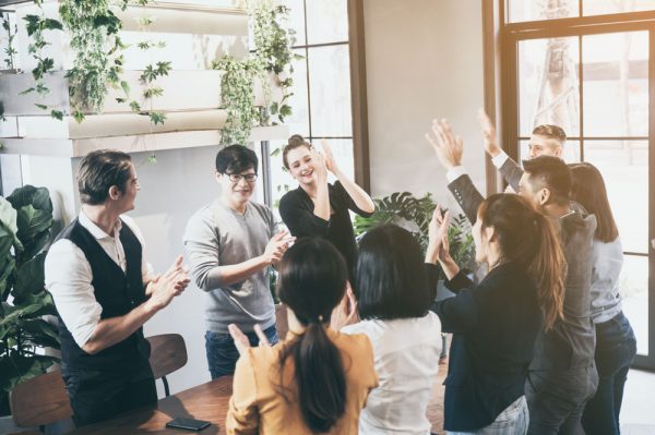 Successful business group of people at work showing joy and fulfilment