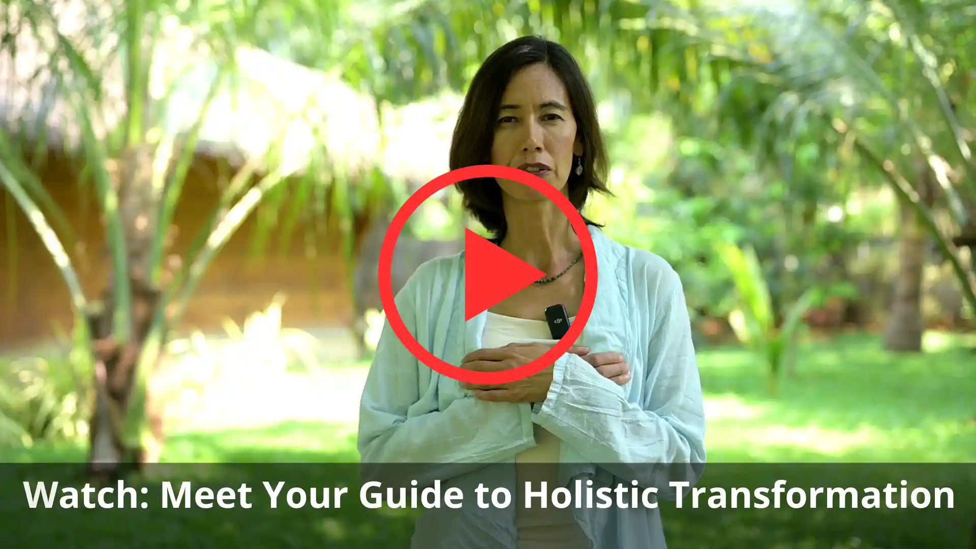 ThaoQi holistic coach smiling in a garden with hands over heart, invitation to watch transformation video trailer